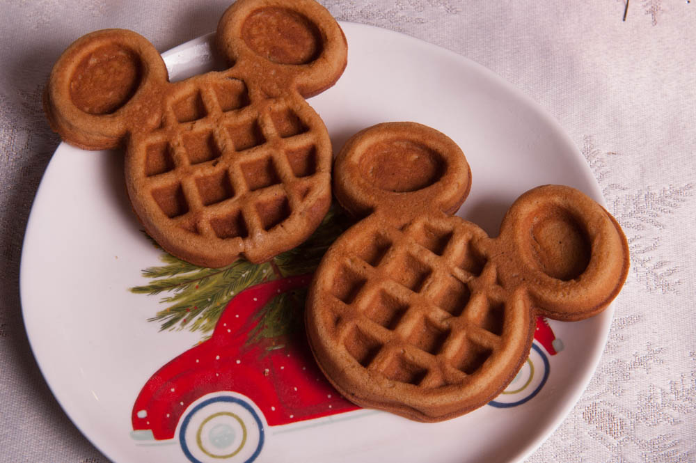 Two Pumpkin Spice Mickey Waffles on a Holiday Plate | Disney's Very Merry Christmas Party Recipe