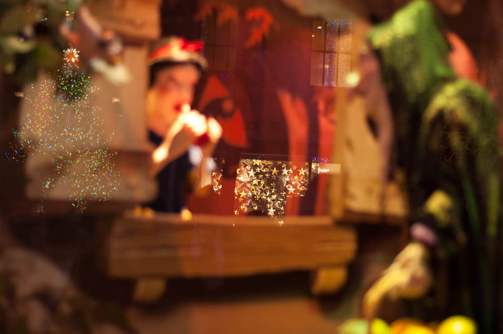 Snow White Sak's 5th Ave Window Display in New York with a reflection of Rockefeller Christmas Tree