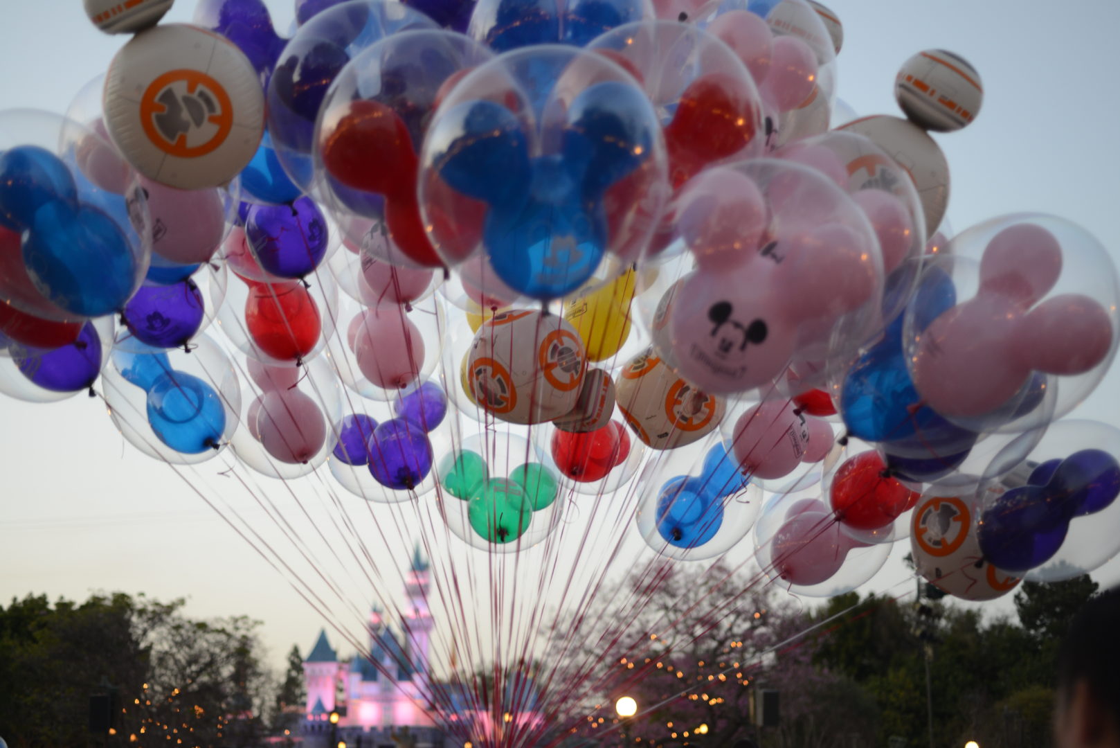 Huge Bouquet of Disneyland Balloons in front of Sleeping Beauty Castle at Dusk