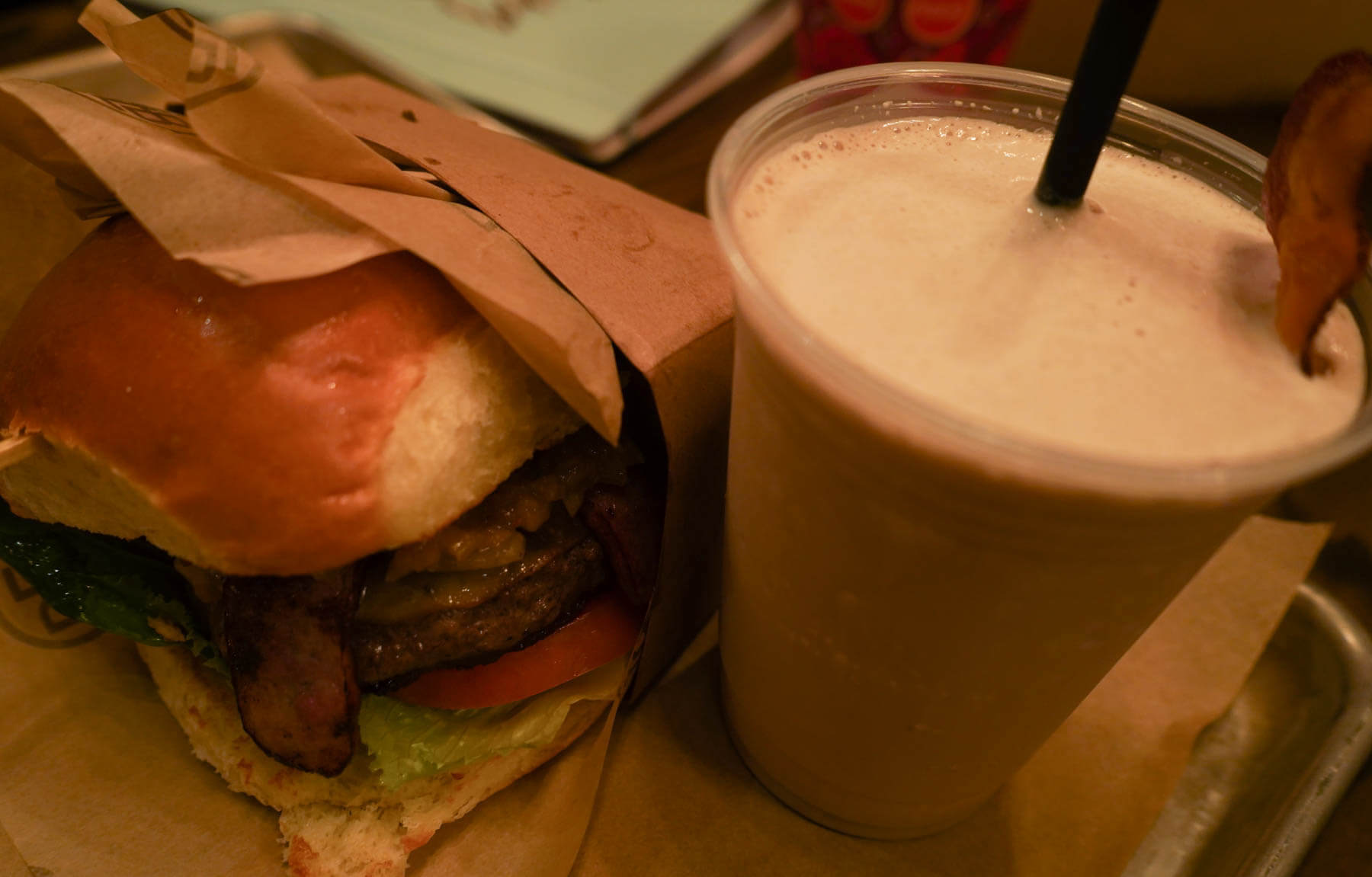 Autumn Harvest Burger with apple whiskey jam and smoked sausage and Maple Bourbon Bacon Milkshake - Disney Springs D-Luxe Burger