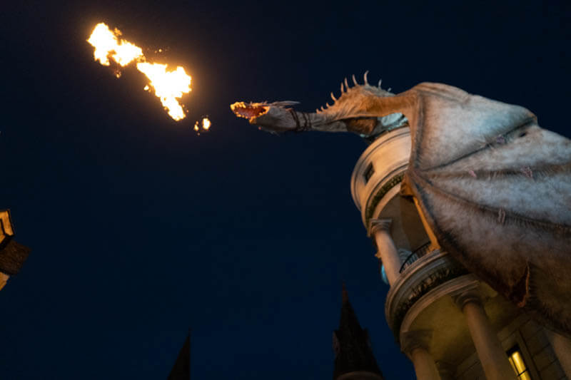 Dragon breathing fire in the Wizarding World of Harry Potter Orlando at night