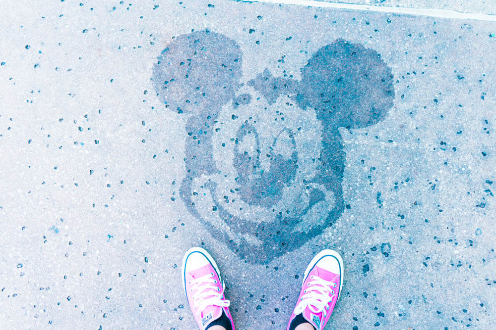 Hidden Mickey on sidewalk of All Star Resort with pink converse shoes