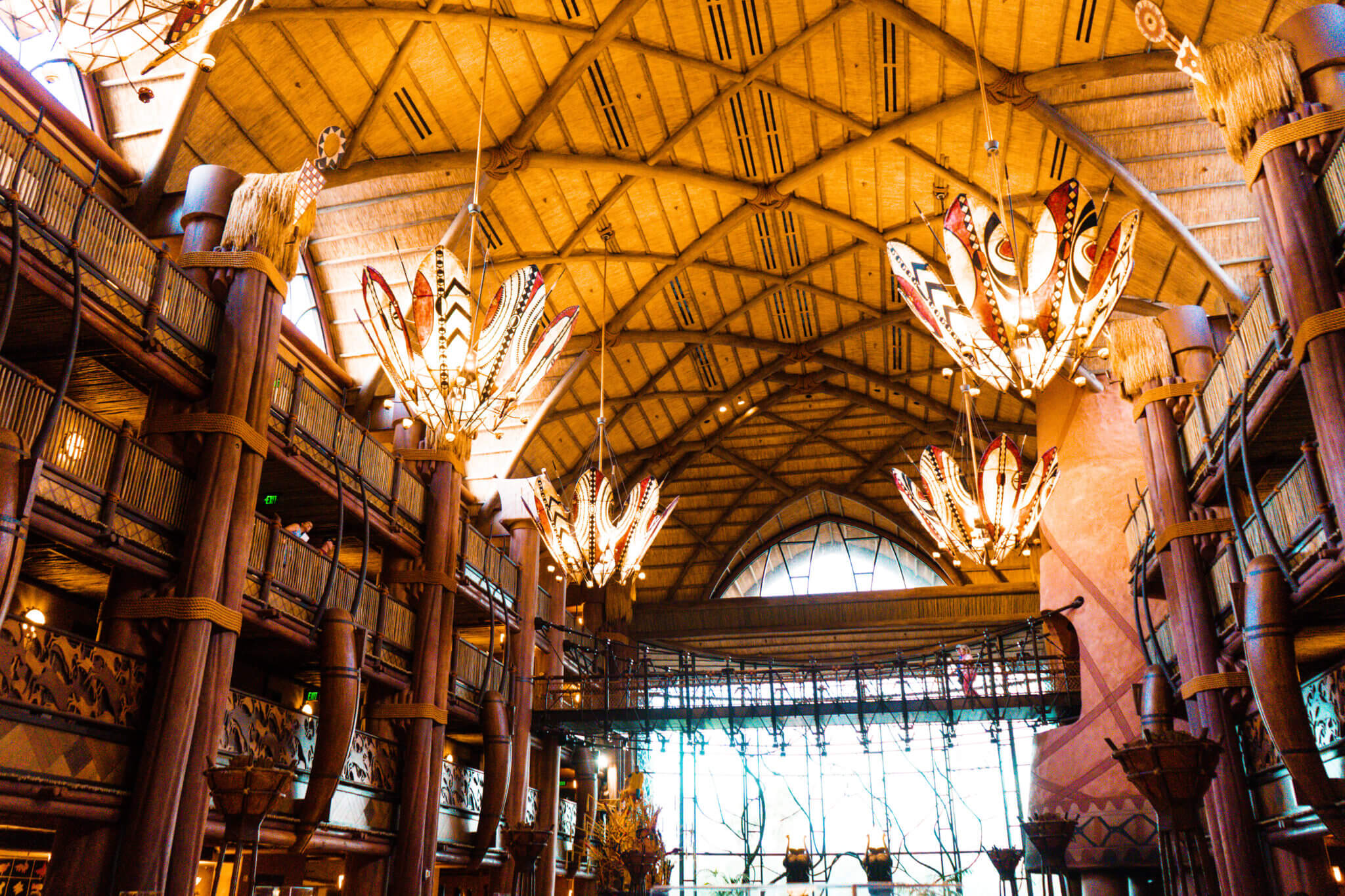 Warmly lit Animal Kingdom Lodge lobby and chandeliers at Disney World