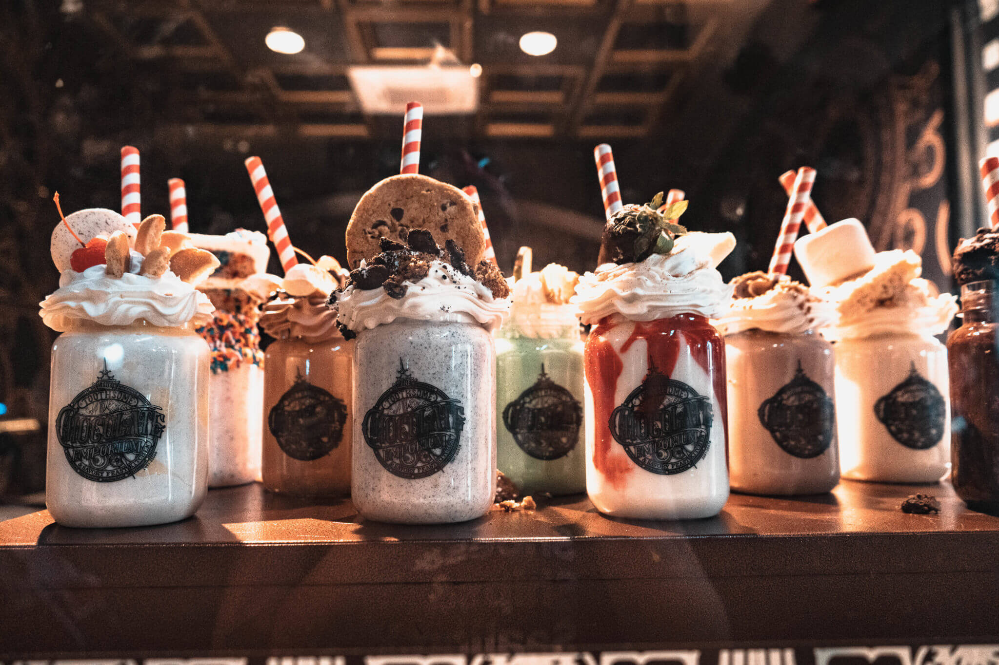 Display of chocolate, red velvet, and marshmallow milkshakes from Toothsome Chocolate Emporium and Savory Feast Kitchen in Universal Studios CityWalk